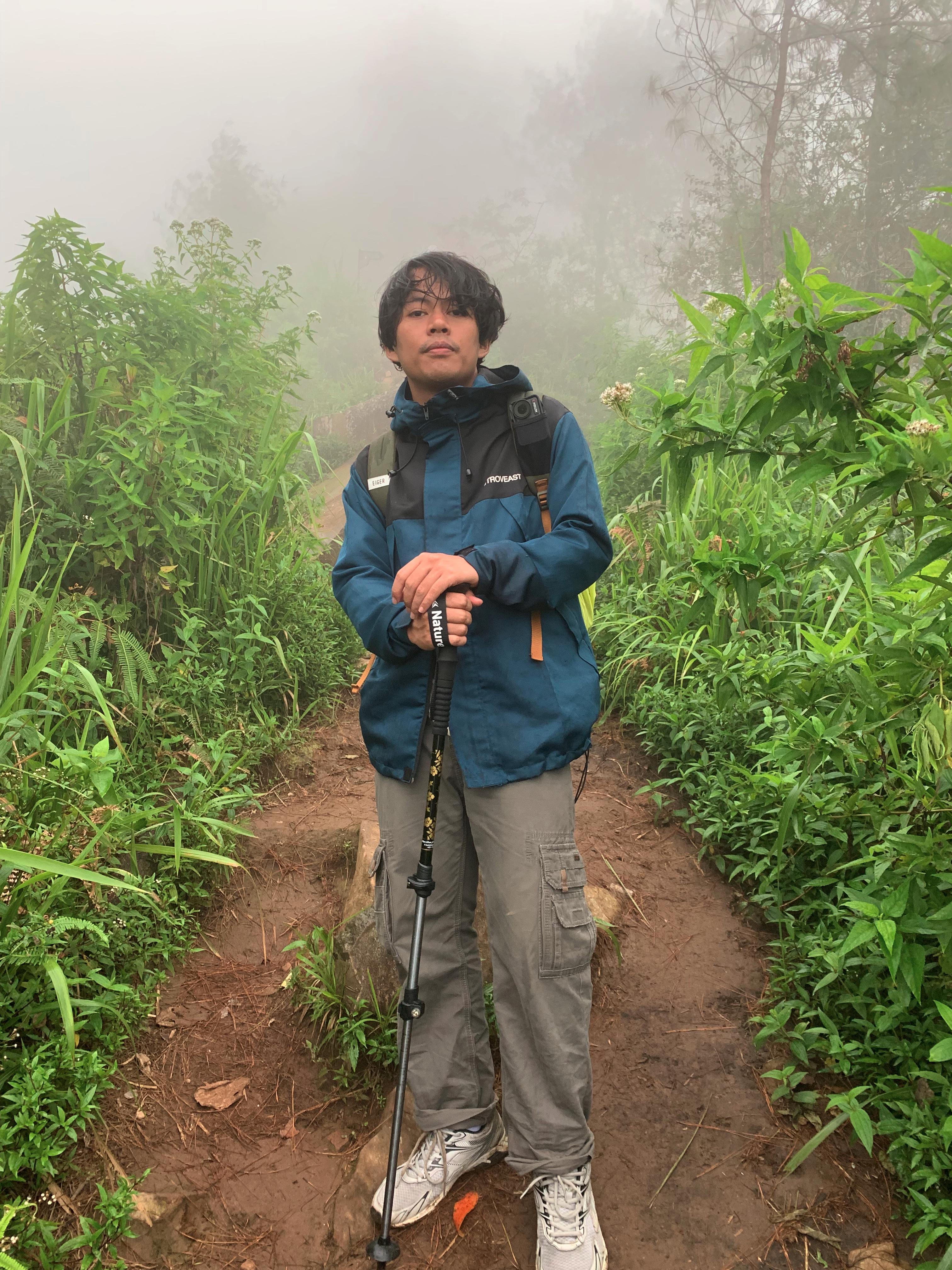 On the foggy trail with hiking poles