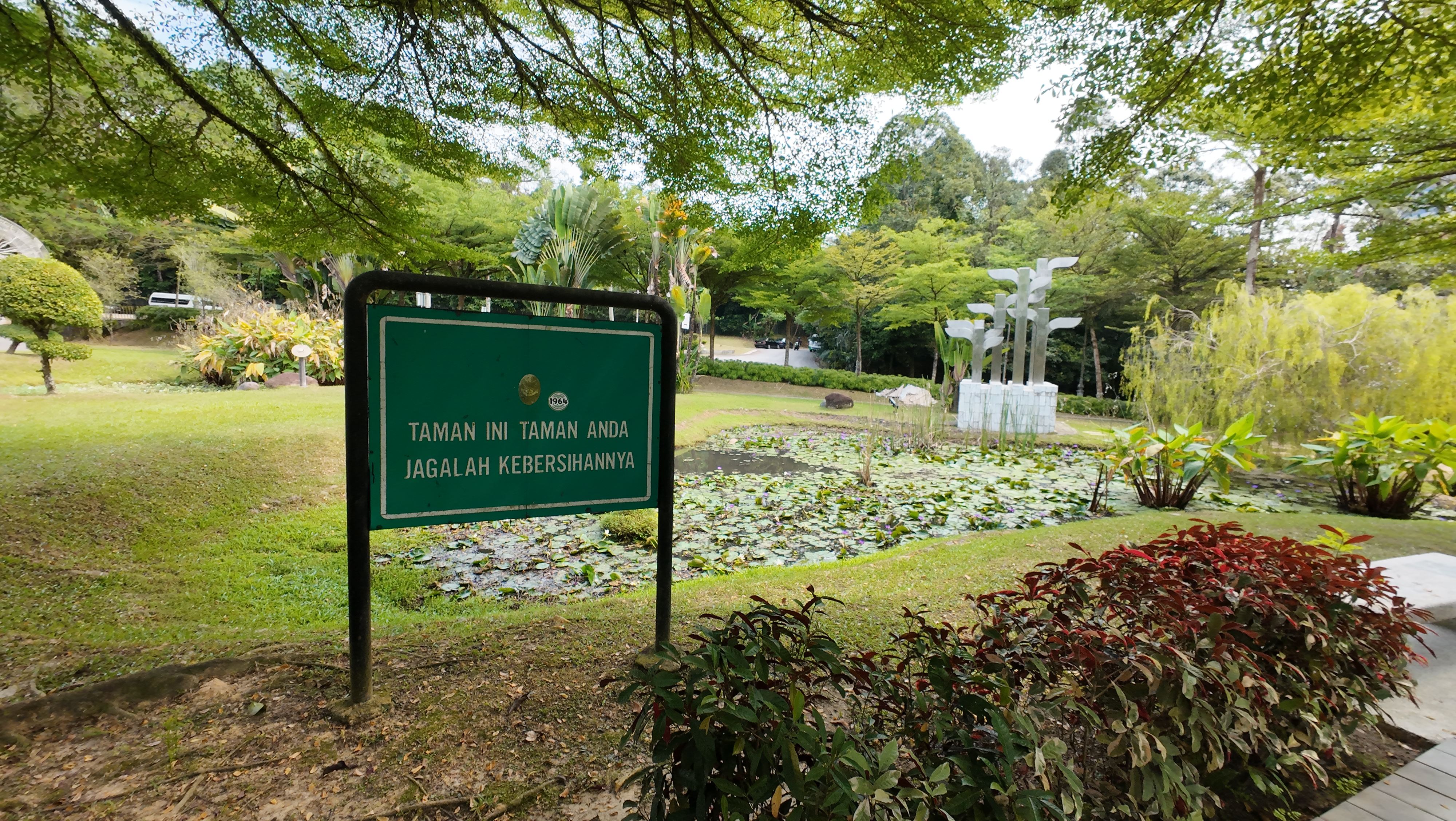 The park sign: "Taman Ini Taman Anda - Jagalah Kebersihan"